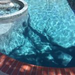 Midnight Microfusion pebble pool surface, turquoise colored pool finish, teal pool surface