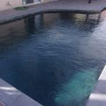 Black Pebble Pool Finish with Shadows from the house