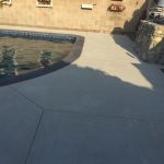 Pool with dark coping and concrete deck