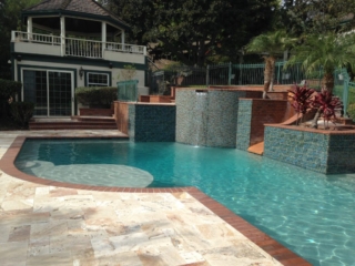Raised Spa with slide, baja Bench Travertine deck brick coping