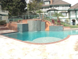 Raised Spa with slide, baja Bench Travertine deck brick coping