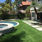 Pool and Spa with Artificial Grass white coping and stack stone on raised bond beam