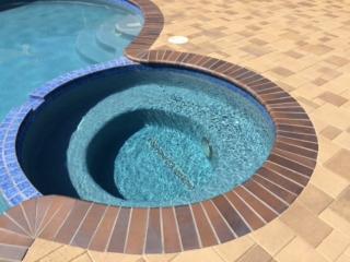 spa with crystal blue radiance brick coping brown flash and orco vill pavers
