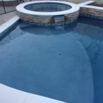pool spa raised bond beam stack stone baja bench