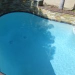 Pool with raised bond beam and stack stone