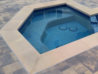 Spa with drains and pebble finish