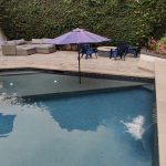 Pool with Baja Bench with umbrella and pavers